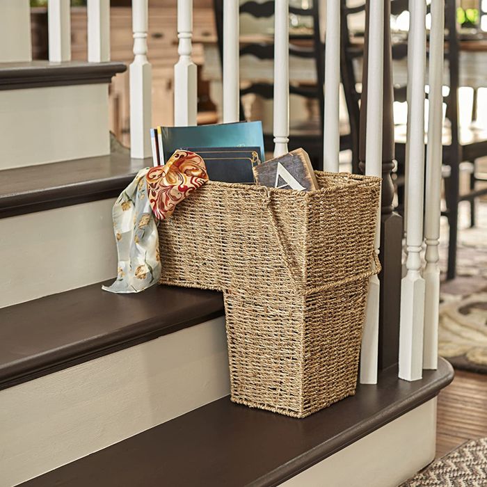A two-tier wicker basket designed to fit perfectly on stair steps