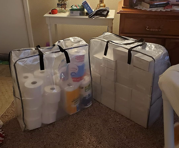 a reviewer's two large square bags filled with household supplies
