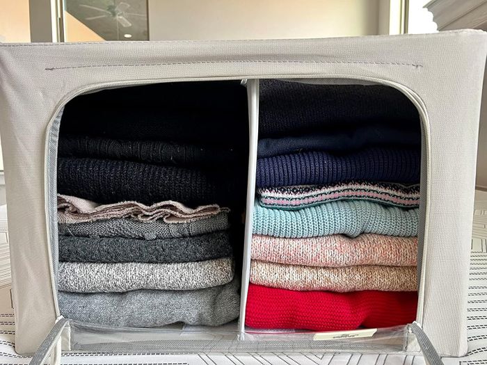 A reviewer’s storage container displayed from the front, unzipped to reveal two neatly divided stacks of clothes.