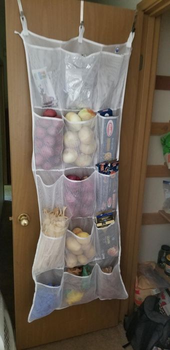 a reviewer's organizer hanging in their pantry, neatly storing various food items