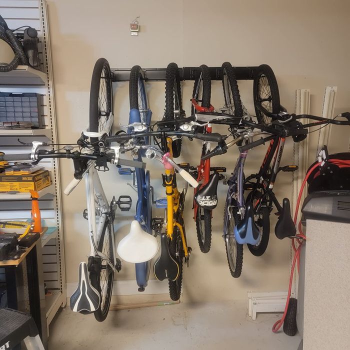 A reviewer’s wall-mounted rack holding six bikes neatly in place.