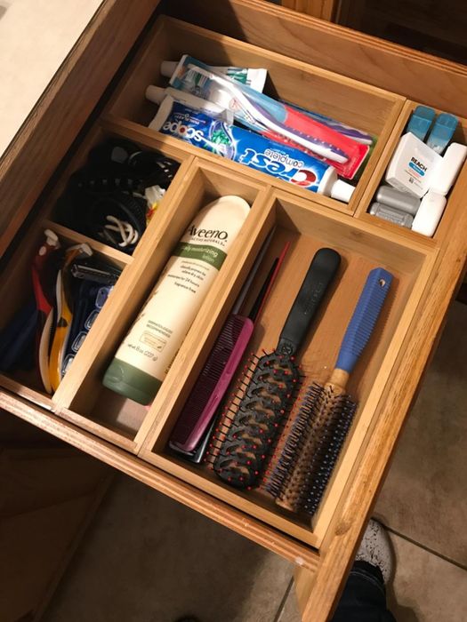 A reviewer’s bathroom drawer showcasing the organizers neatly holding an assortment of bathroom essentials.