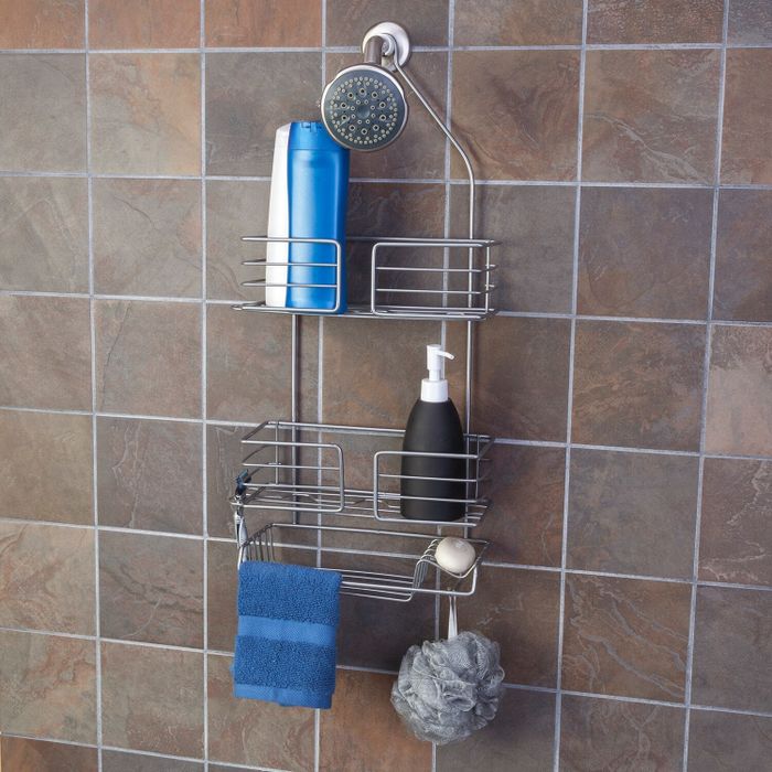 a steel shower caddy installed in the shower