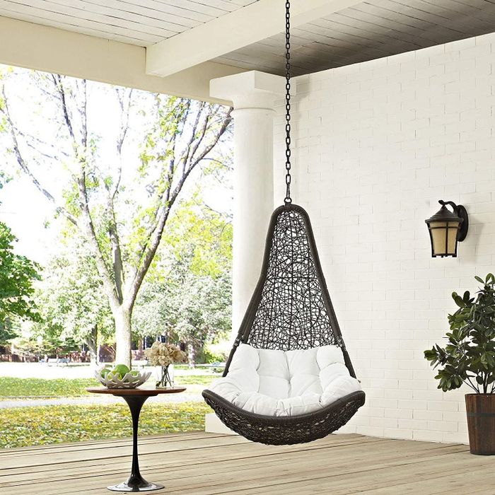 the hanging chair placed on a porch