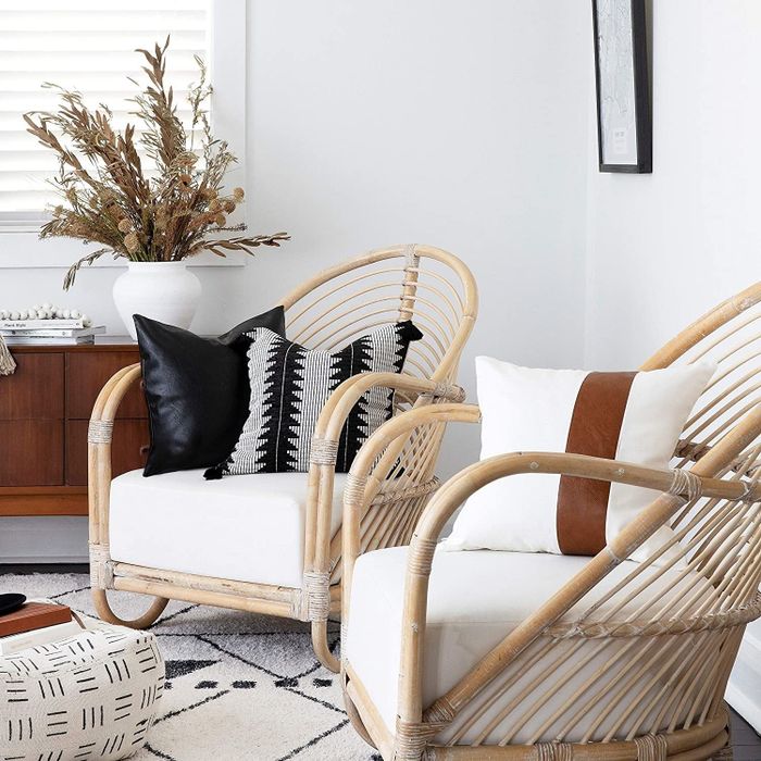 the pillows adorning a pair of accent chairs