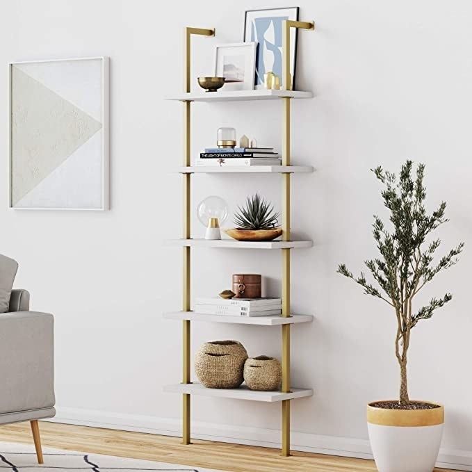 The bookshelf in a sleek gold and white design