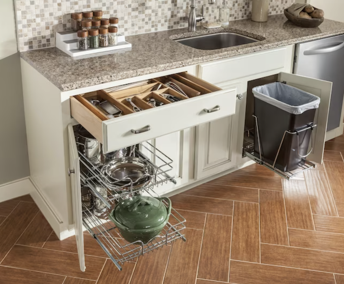 The silverware organizer placed inside a white kitchen drawer
