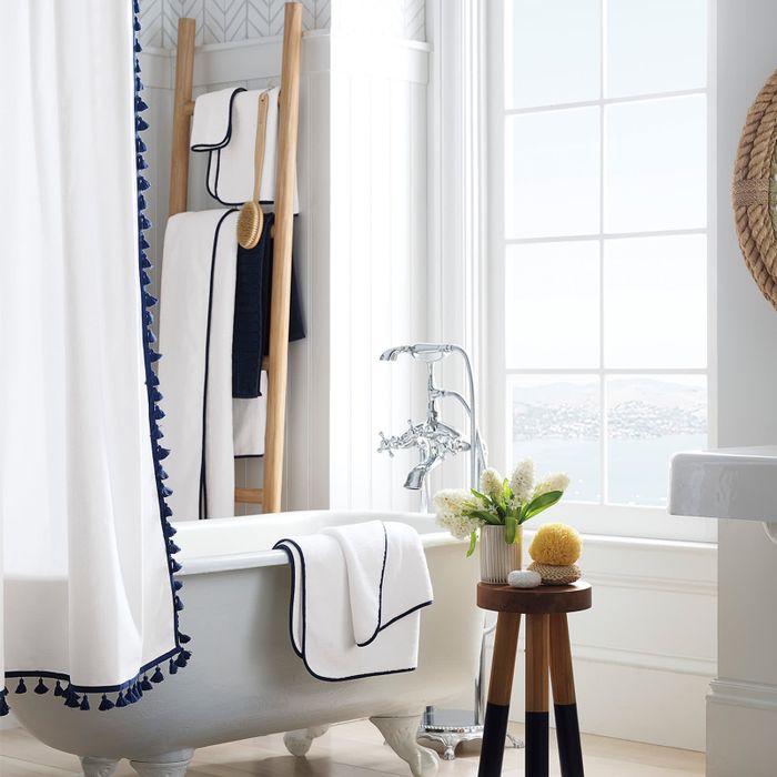 the blue dip-dyed stool positioned next to a bathtub