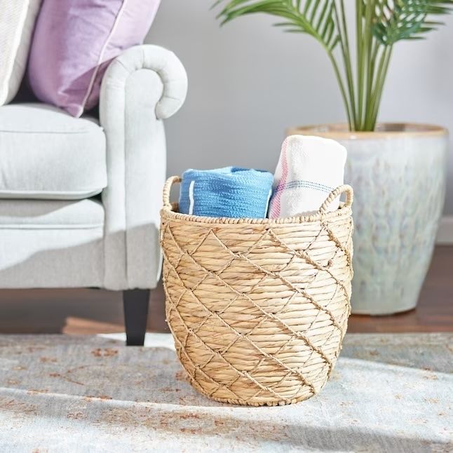 a woven basket filled with cozy blankets