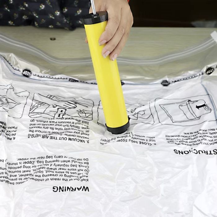 a person removing air from a storage bag