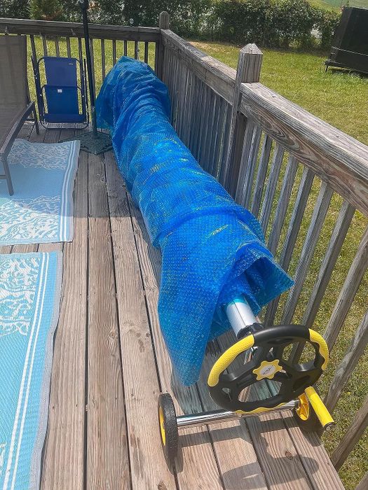 A reviewer photo of the pool cover wrapped around the pool cover reel