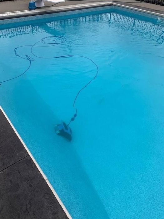 A reviewer’s photo showing the robotic vacuum in action, cleaning the now pristine pool