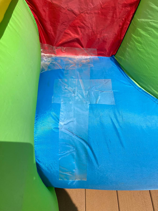 An inflatable structure with a taped repair on a blue section