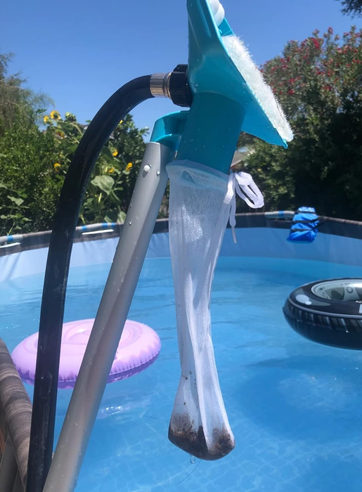 A reviewer photo showing the vacuum with debris from the pool collected inside the provided bag