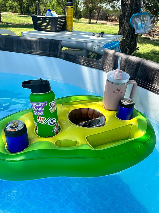 An inflatable drink holder in a pool filled with beverages and a tumbler