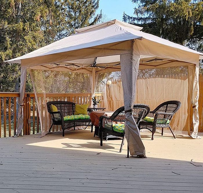 Reviewer's white pop-up gazebo set up on a deck.