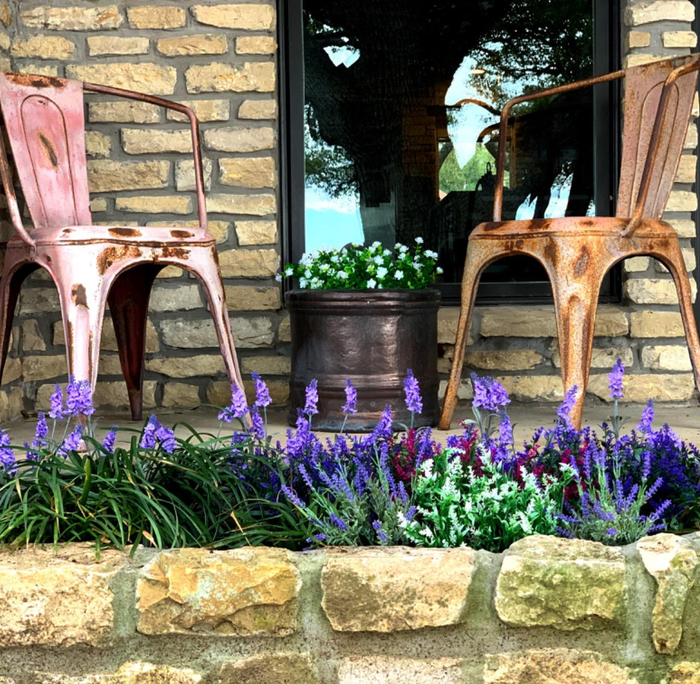 The purple flowers arranged in a stone planter.