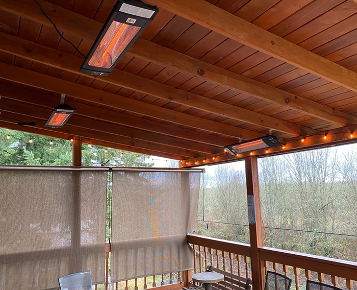 Three heaters mounted on the ceiling of a covered deck.