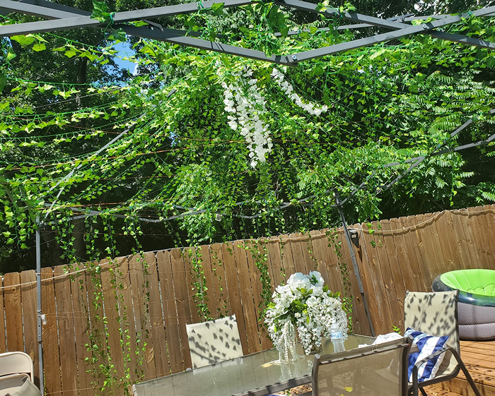 Reviewer's ivy garland arranged above an outdoor patio table.