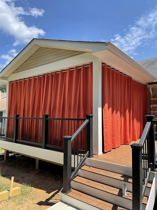 Red curtains draped over a reviewer's deck.