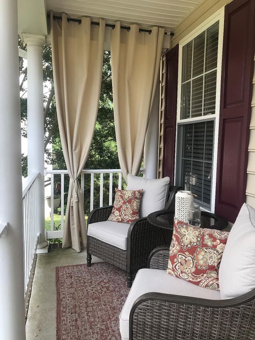 Reviewer's beige curtains covering one side of their porch.