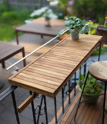 The table securely attached to a railing for easy use.