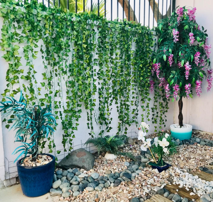 Reviewer's ivy garland hanging on a tall outdoor wall.