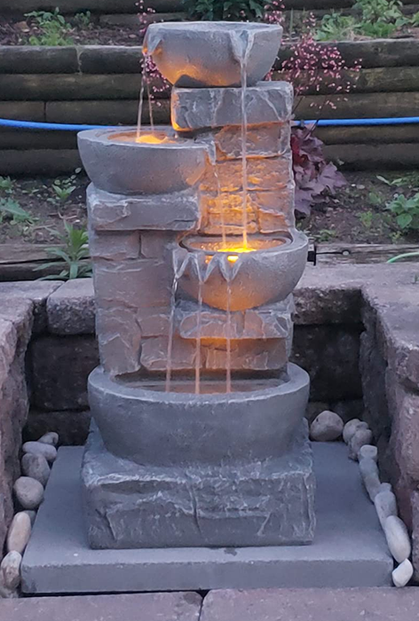 The waterfall glowing softly at dusk, casting a serene ambiance.