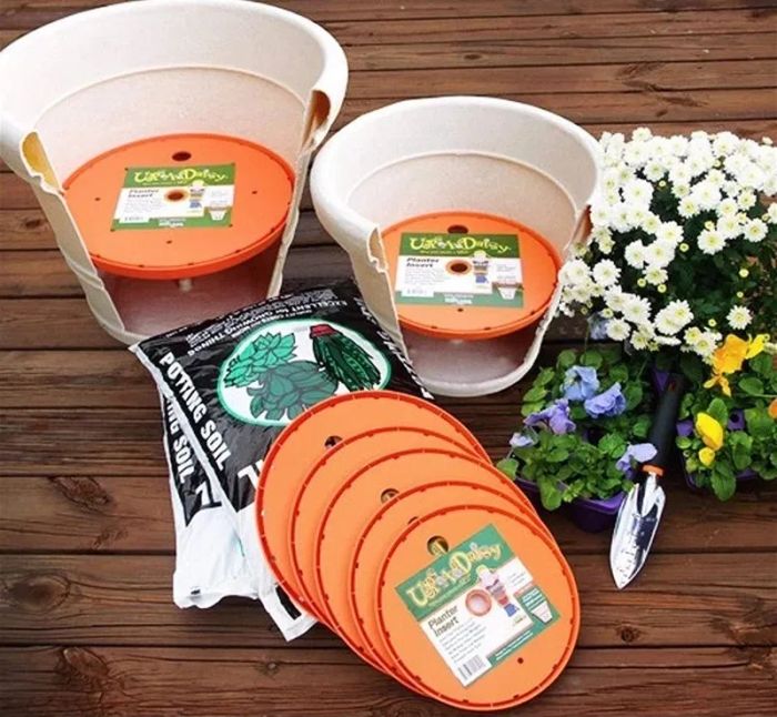 Orange planter inserts displayed alongside other gardening items
