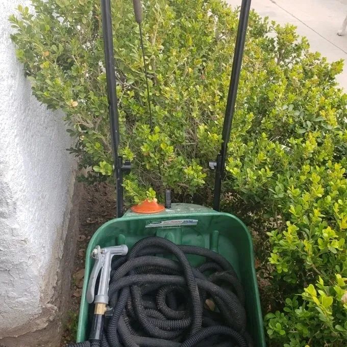 Reviewer photo showing the hose in a green garden cart