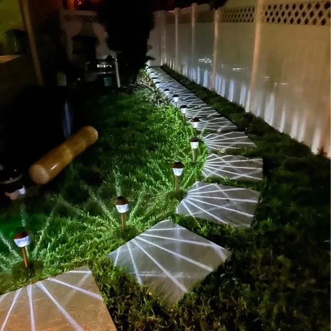An image from a reviewer showing the garden lights illuminating a pathway.