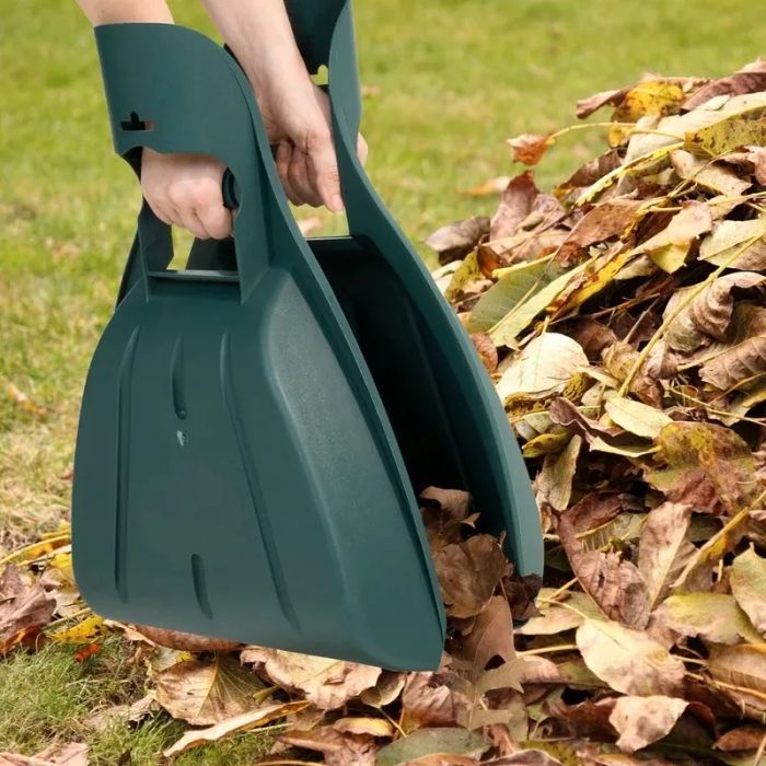 Person using the hand rake claws to collect leaves