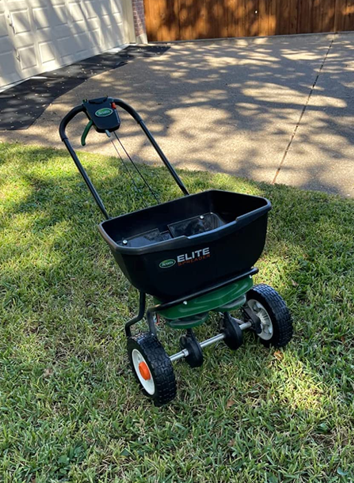 A reviewer's photo of the Turf Builder in action on a lawn