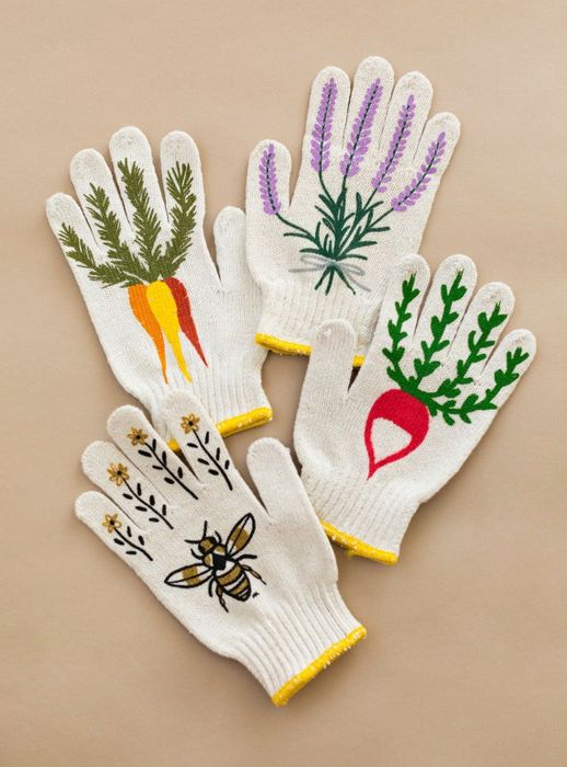 Four different pairs of gardening gloves featuring various plant designs