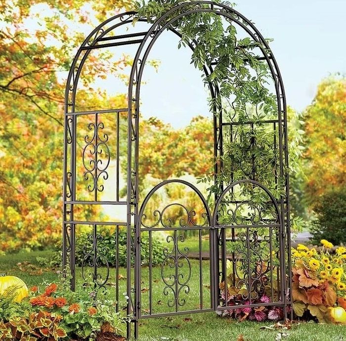 The iron arbor featuring a gate for added charm.