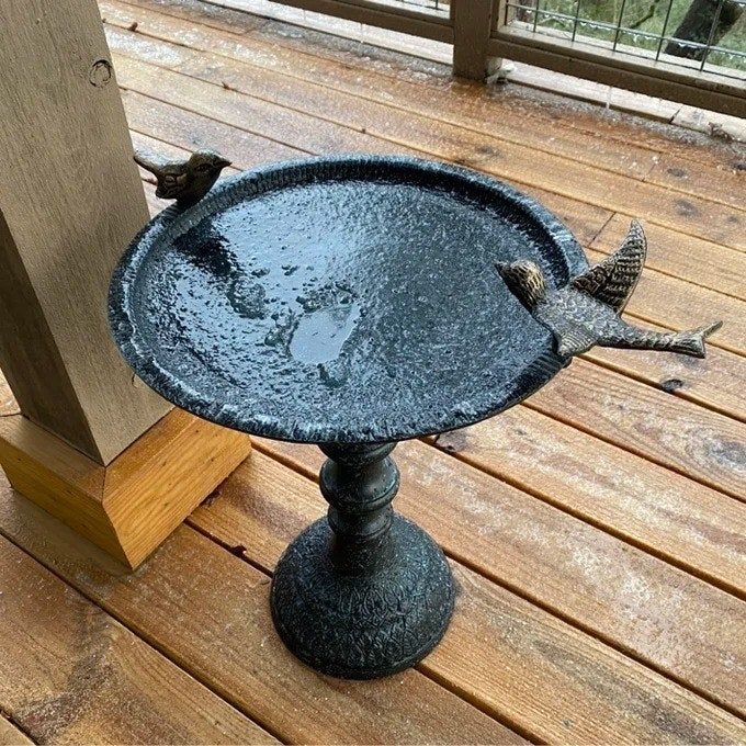 A reviewer’s photo showcasing the birdbath on a deck, adding charm to the outdoor space.
