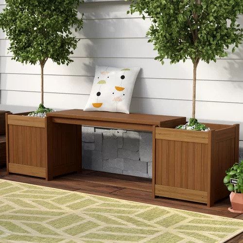 A bench adorned with small trees planted in boxes, giving off natural vibes.