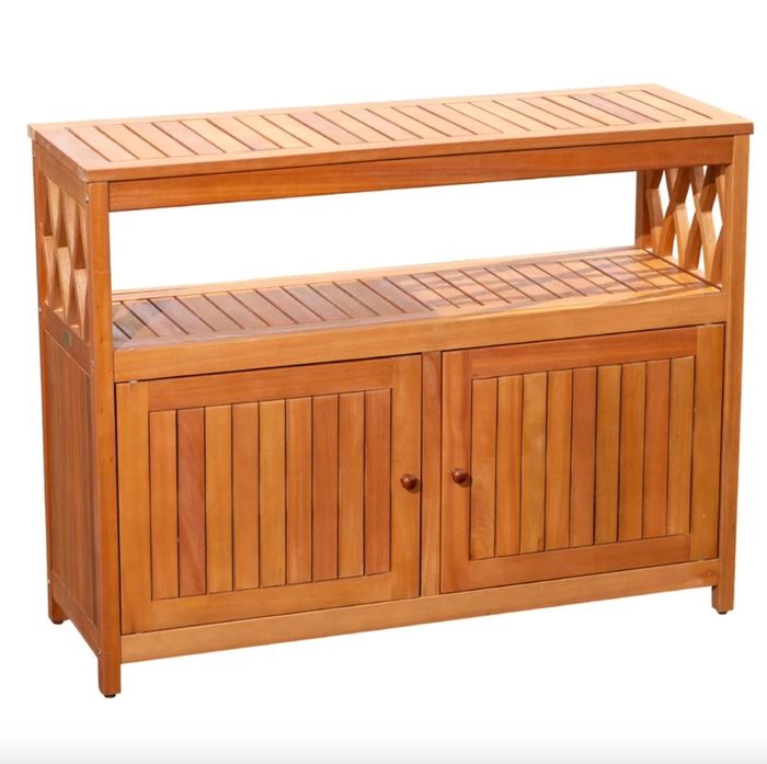 A light wood console table with cabinets at the bottom and an open space under the top, perfect for storing and displaying items.