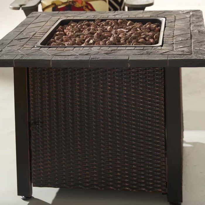 A brown and black fire pit table with a lava rock center, perfect for cozy evenings.