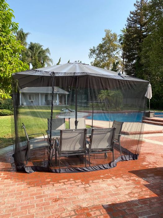 reviewer image of the netting placed over a patio furniture set outside