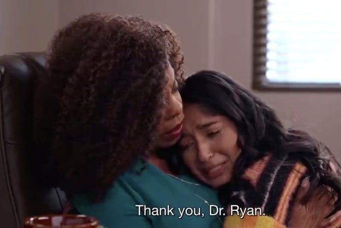 Two individuals share a heartfelt moment, seated in an office. The screen displays the words, "Thank you, Dr. Ryan."