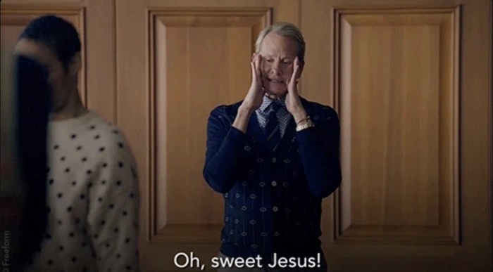 A person dressed in polka dot attire holds their face in their hands, looking shocked. Text reads, 'Oh, sweet Jesus!'