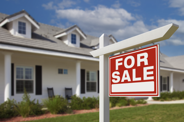 house with a 'for sale' sign