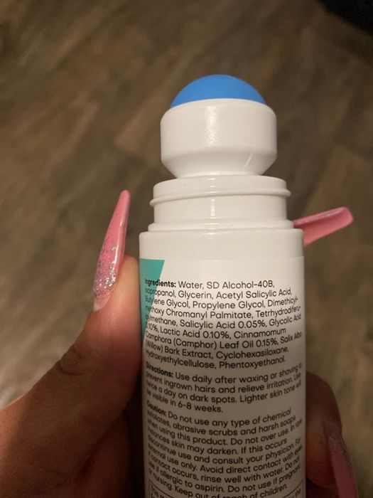 Tube opened to show the roller applicator and a list of ingredients