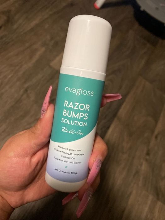 Reviewer holding a tube of roll-on aftershave