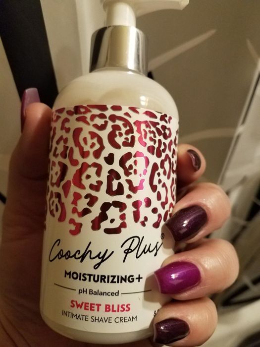 Model holding Coochy Plus shave cream