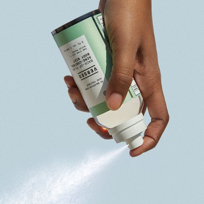 Model spraying green body mist from a can
