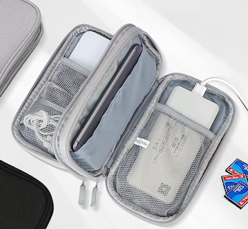 The organizer is opened, showing a charger and cords neatly arranged inside.