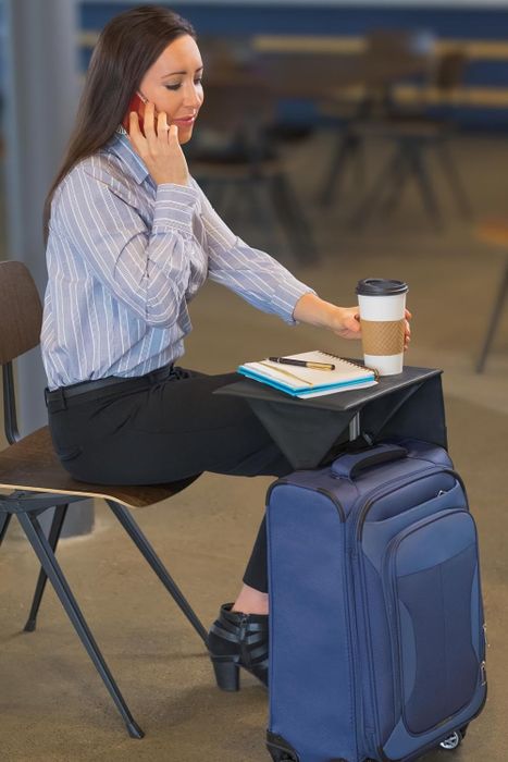 A model using the tray to sit comfortably, sip coffee, and write in a journal.
