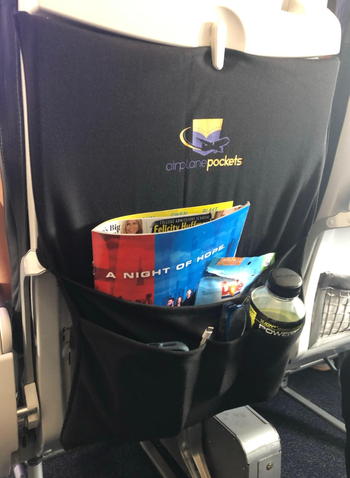 The pocket holds magazines and a water bottle.